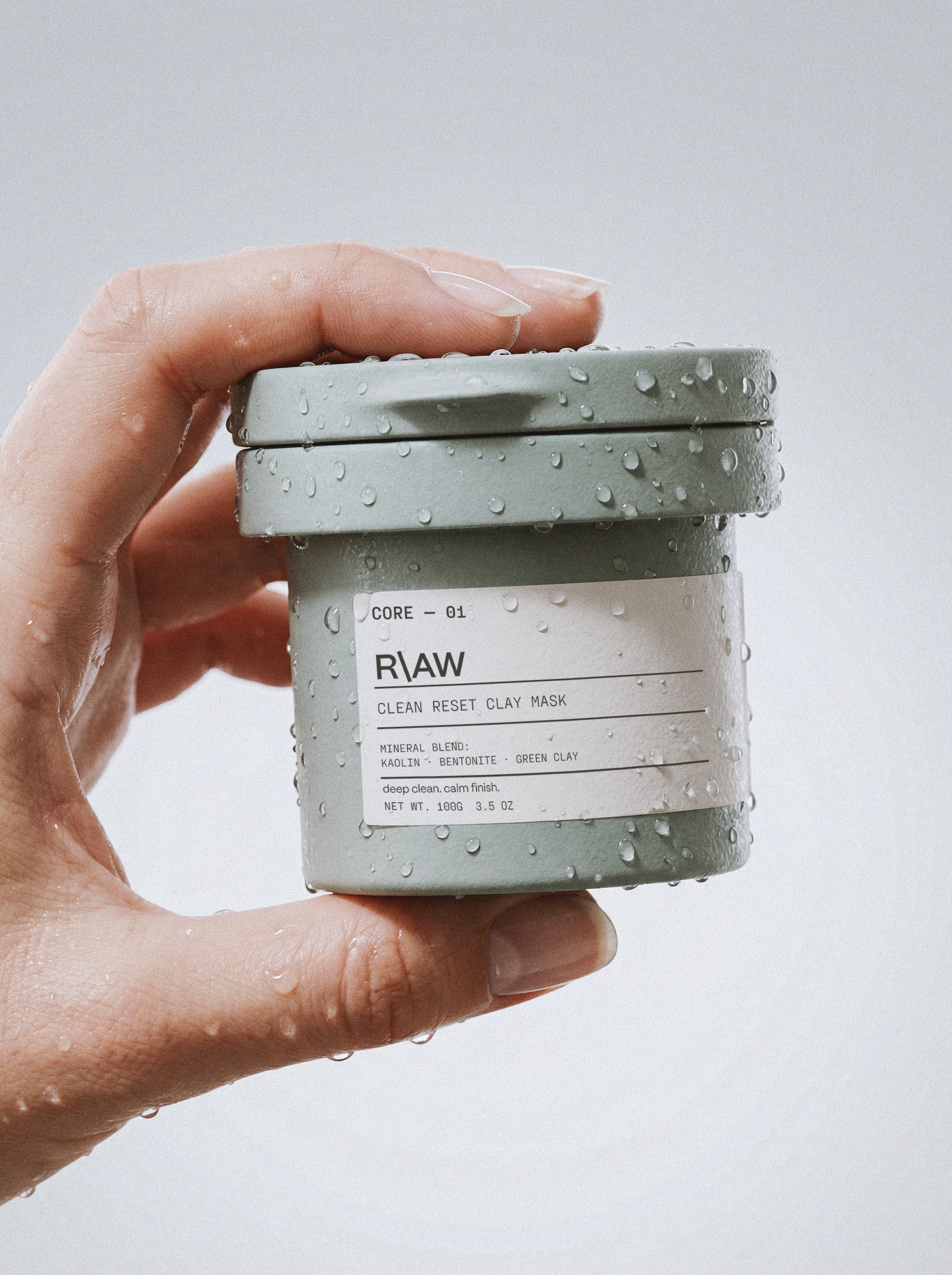 premium skincare packaging design showcasing a wet clay mask jar with water drops for R\AW